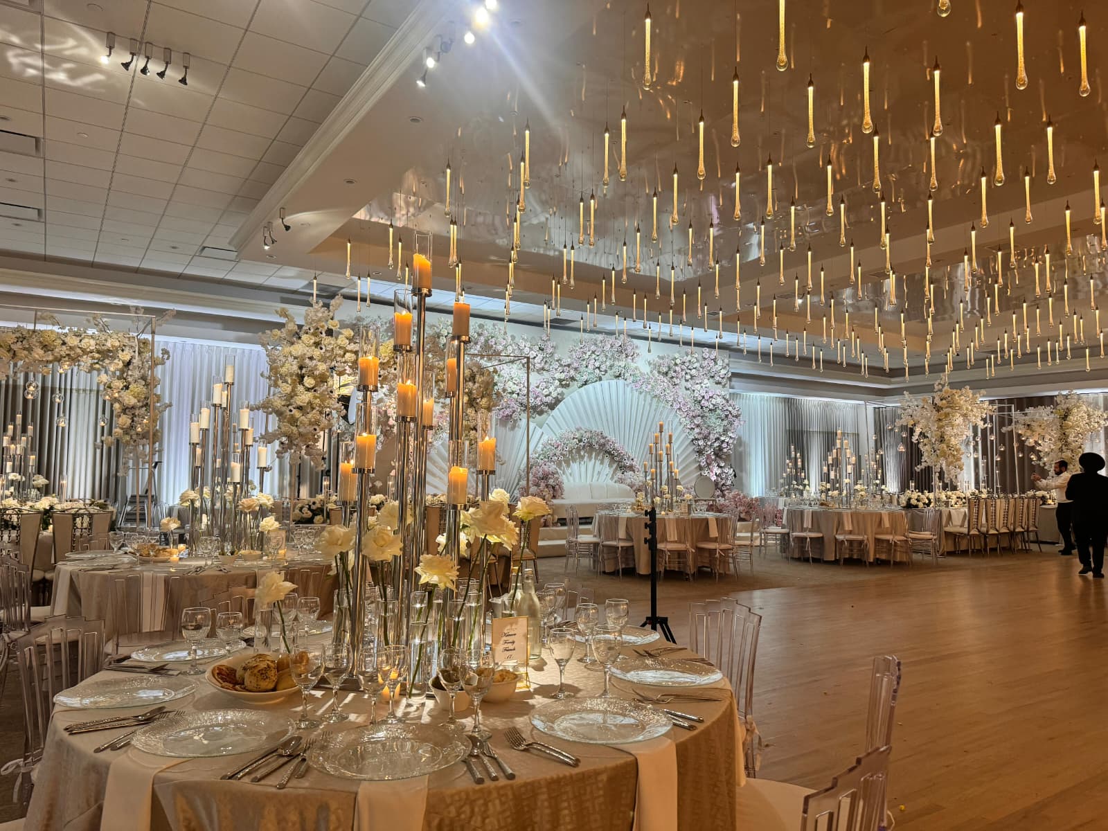 Tables with tall floral and candle arrangements