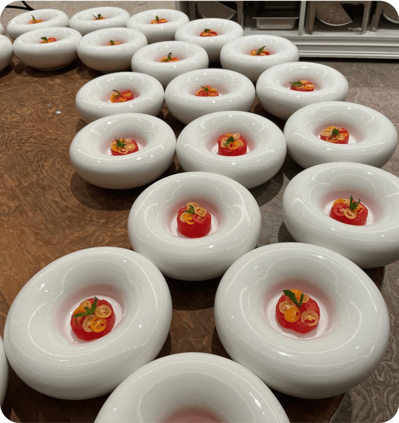 Rows of plated starters in white bowls