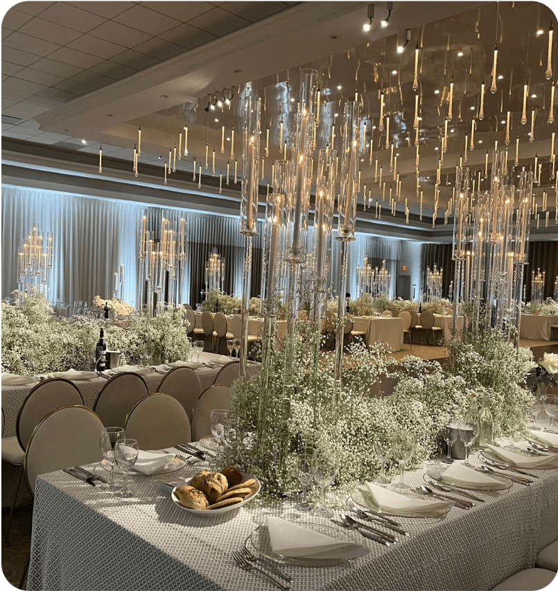 Long tables lined with baby's breath under suspended lights