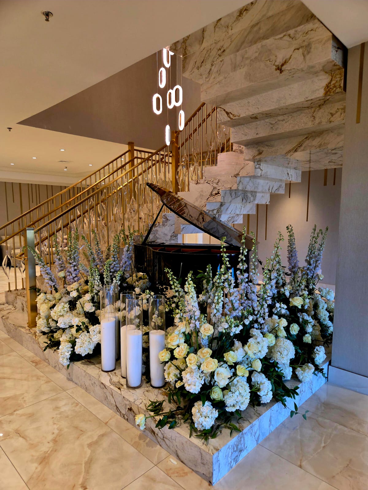 The marble staircase and grand piano dressed with florals
