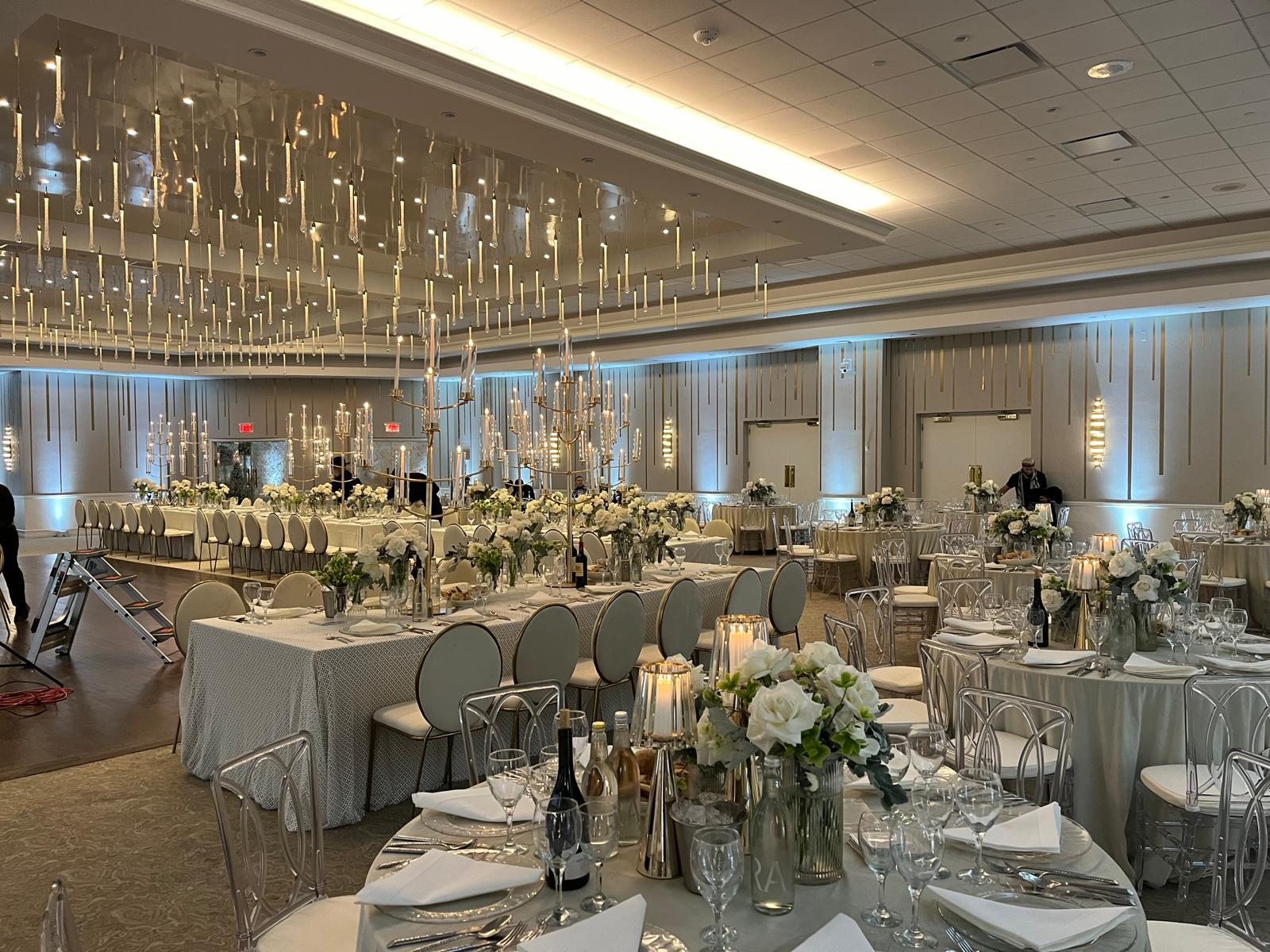Ballroom set with round tables, florals and candlelight